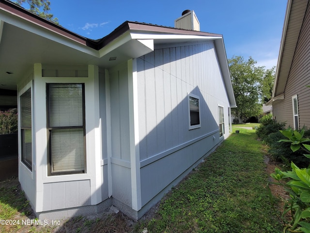 view of side of property with a yard