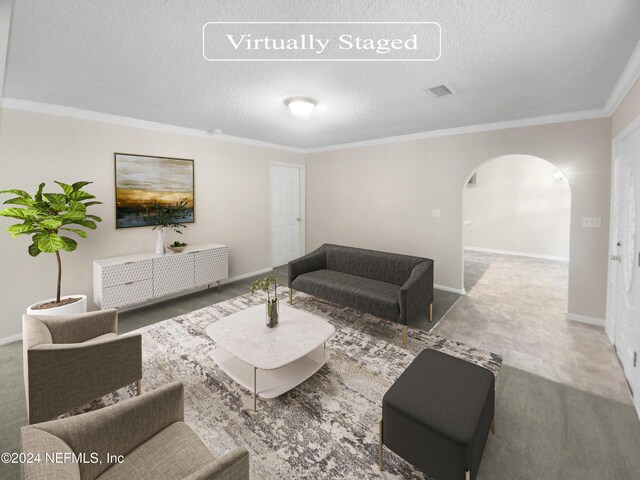 living room featuring tile patterned floors, a textured ceiling, and crown molding