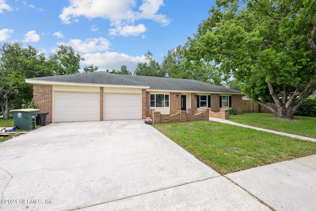 ranch-style house with a garage and a front lawn