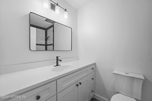 bathroom featuring toilet and vanity