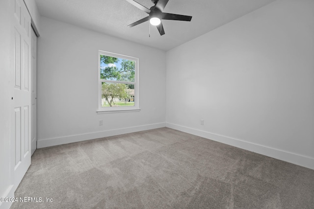 unfurnished room featuring light colored carpet and ceiling fan