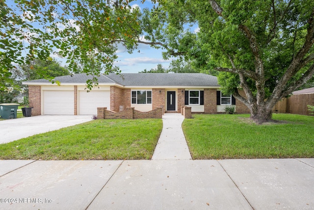 single story home featuring a garage and a front yard