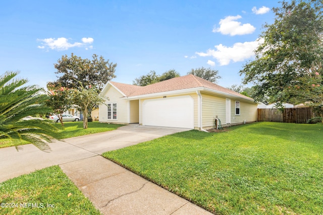 ranch-style home with a garage and a front yard