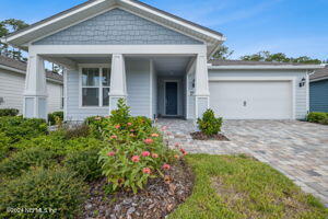 view of front of house featuring covered porch and a garage