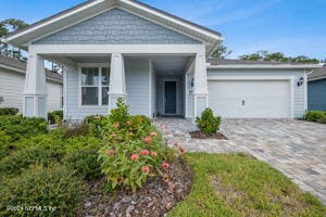 view of front of property with decorative driveway and an attached garage