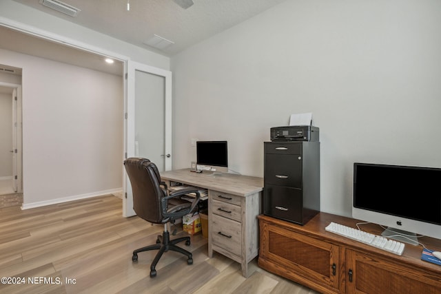 office featuring visible vents, light wood-style flooring, and baseboards