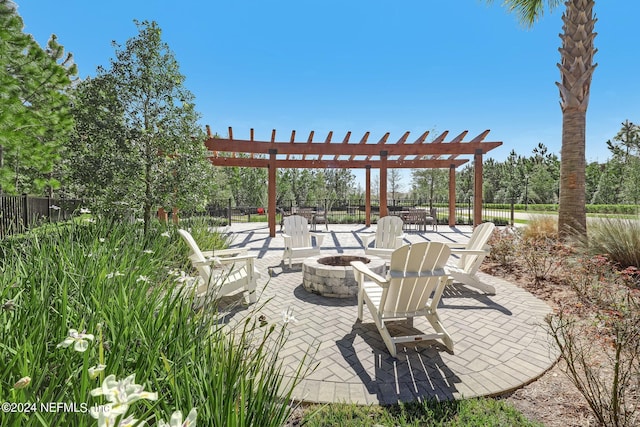 view of patio with a fire pit, fence, and a pergola