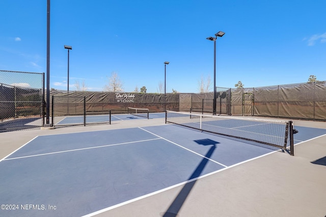 view of tennis court with fence