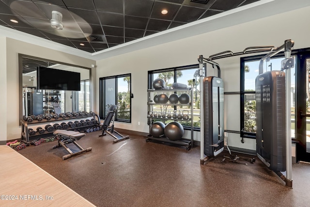 gym with a drop ceiling, visible vents, and baseboards