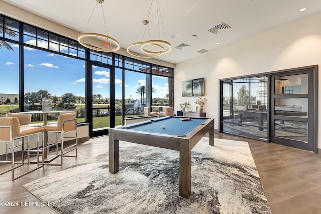 playroom featuring pool table, wood finished floors, visible vents, and a healthy amount of sunlight