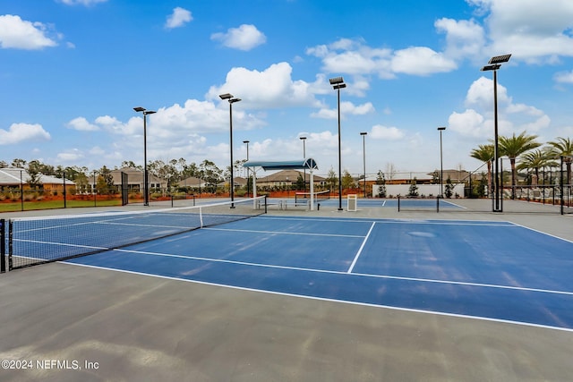 view of tennis court featuring fence