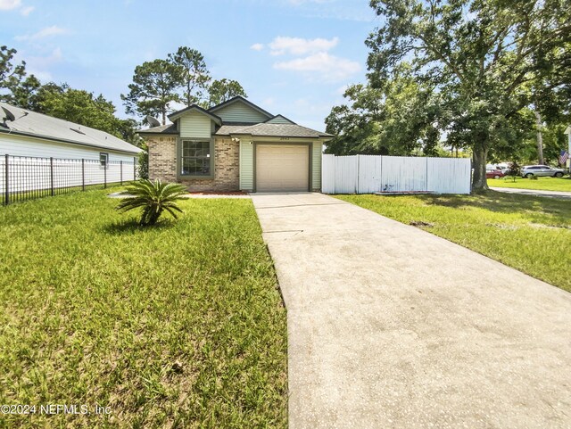 single story home featuring a front lawn and a garage