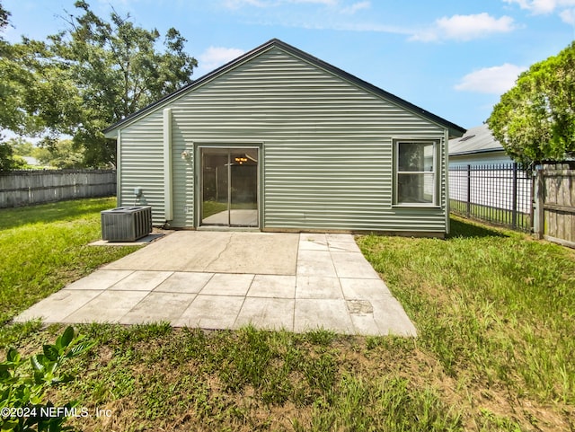 rear view of property featuring a yard, a patio area, and cooling unit