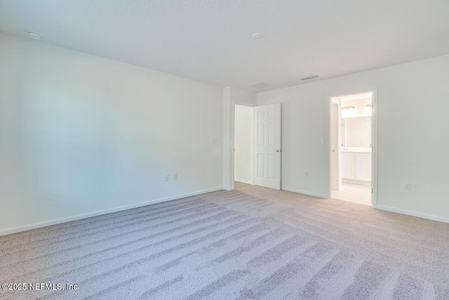 spare room with light carpet