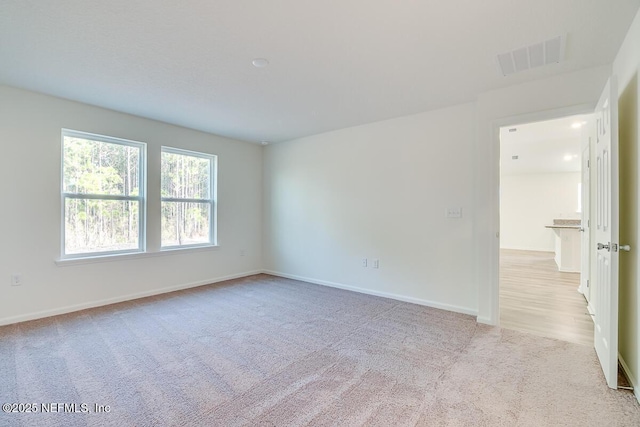 spare room with light colored carpet