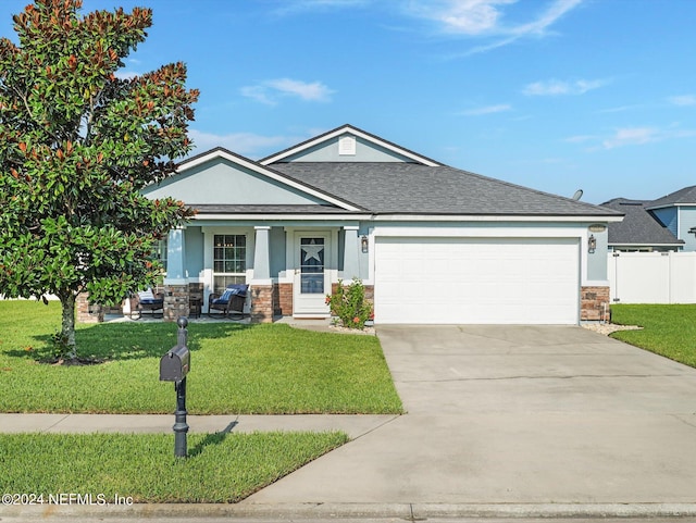 view of front of property featuring a front lawn and a garage