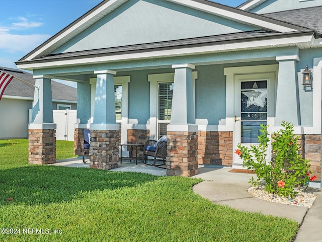 view of front facade with a front yard and a porch