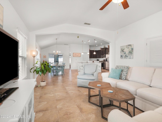 tiled living room featuring vaulted ceiling and ceiling fan with notable chandelier