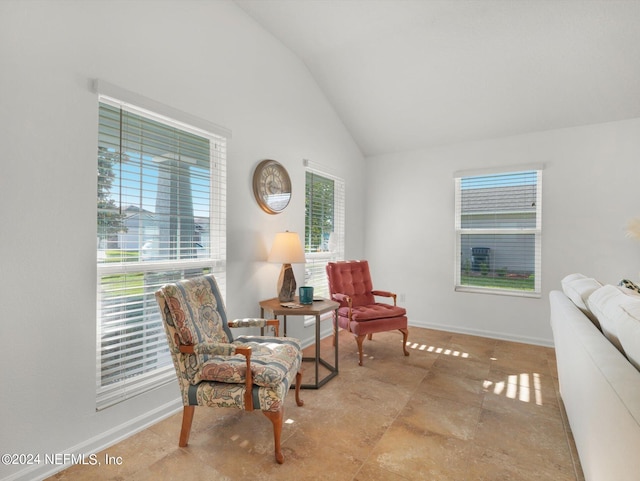 sitting room with lofted ceiling and light tile patterned flooring