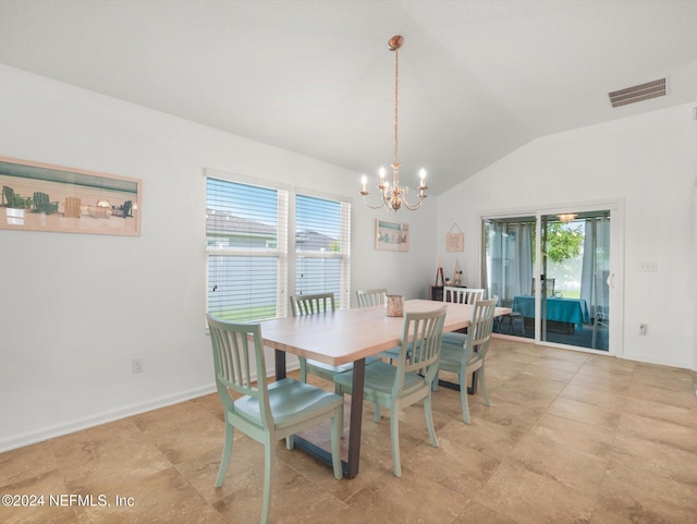 tiled dining space with an inviting chandelier and lofted ceiling