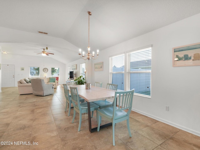 tiled dining room featuring ceiling fan with notable chandelier, lofted ceiling, and a healthy amount of sunlight