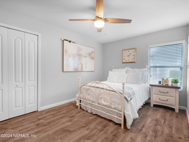 bedroom with a closet, ceiling fan, and hardwood / wood-style floors