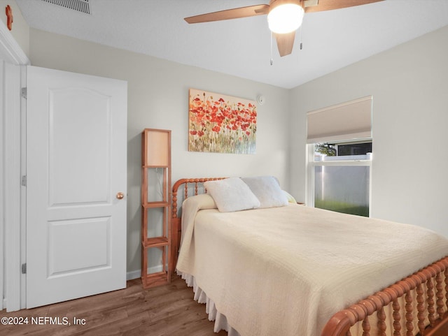 bedroom with ceiling fan and hardwood / wood-style flooring