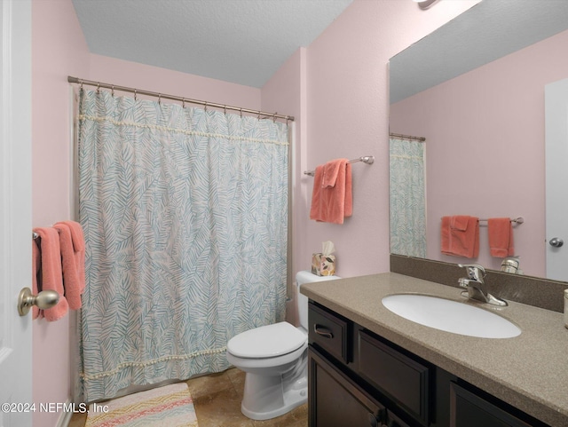 bathroom featuring tile patterned flooring, toilet, and vanity