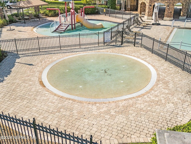 view of pool featuring a patio area and a playground