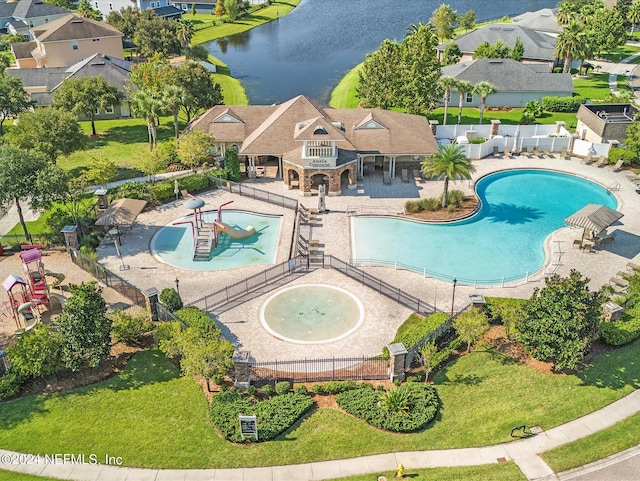 view of swimming pool featuring a yard, a playground, a patio area, and a water view