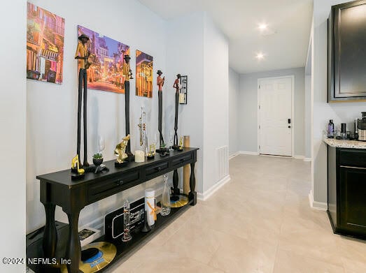 hall featuring light tile patterned floors