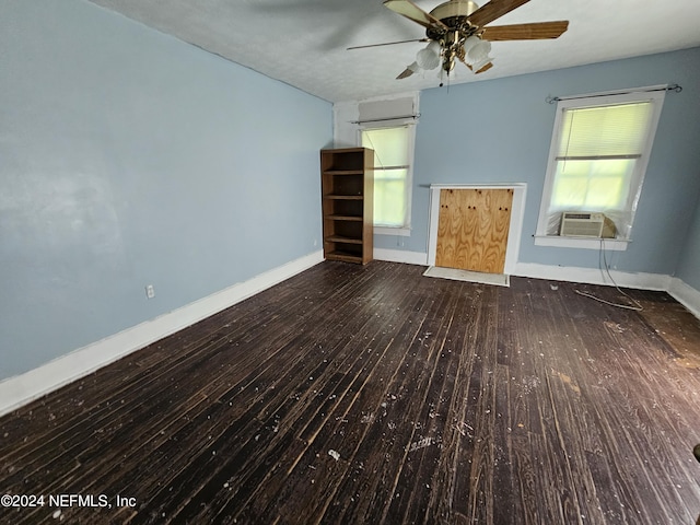 interior space featuring ceiling fan, cooling unit, hardwood / wood-style flooring, and baseboards