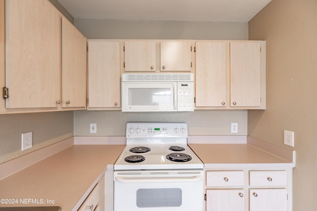 kitchen featuring white appliances and light countertops