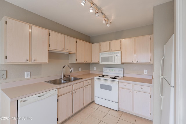 kitchen with light countertops, white appliances, light tile patterned flooring, and a sink