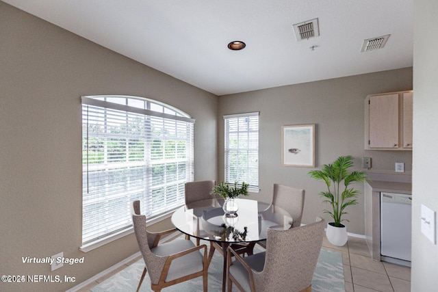 dining area featuring baseboards, visible vents, and light tile patterned flooring