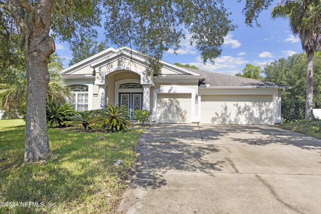 view of front of home featuring a garage and a front lawn