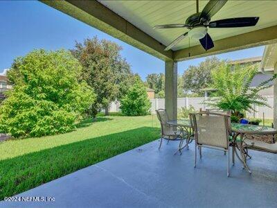 view of patio / terrace with outdoor dining area, a ceiling fan, and fence