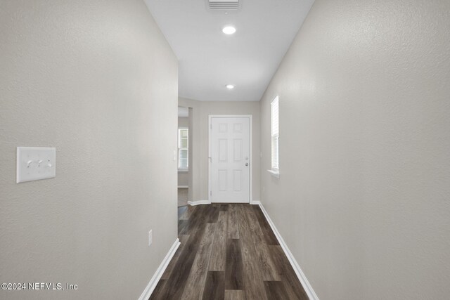 corridor with dark hardwood / wood-style floors