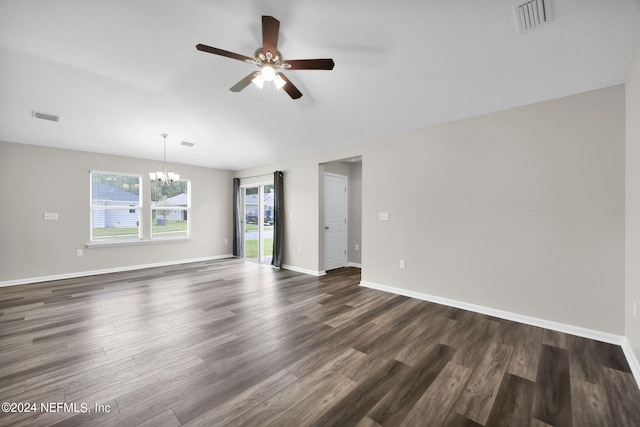 unfurnished room featuring ceiling fan with notable chandelier and dark wood-type flooring