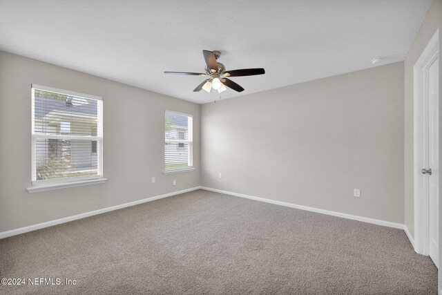 unfurnished room with ceiling fan and carpet floors