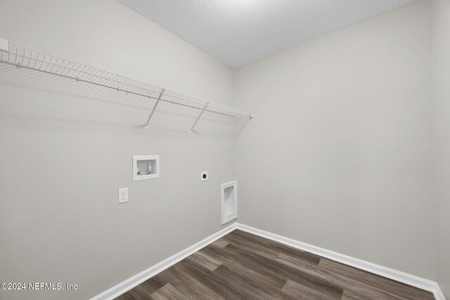 laundry room featuring hookup for a washing machine, hookup for an electric dryer, dark hardwood / wood-style flooring, and a textured ceiling