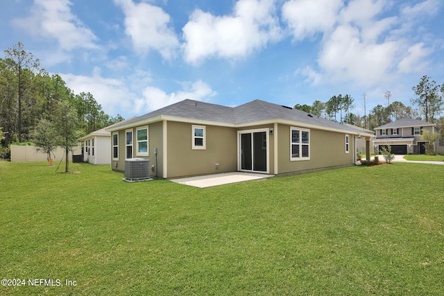 rear view of house featuring a lawn, a patio, and cooling unit