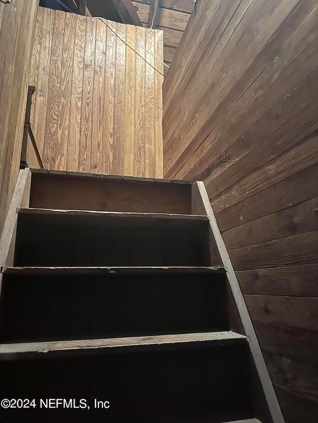 staircase with wooden walls