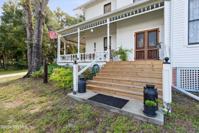 exterior space with central AC unit and covered porch