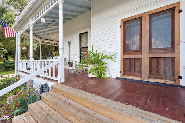 wooden terrace with a porch