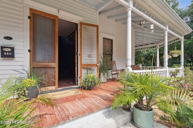 view of exterior entry with a porch