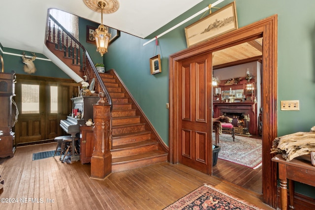 staircase featuring hardwood / wood-style flooring and french doors