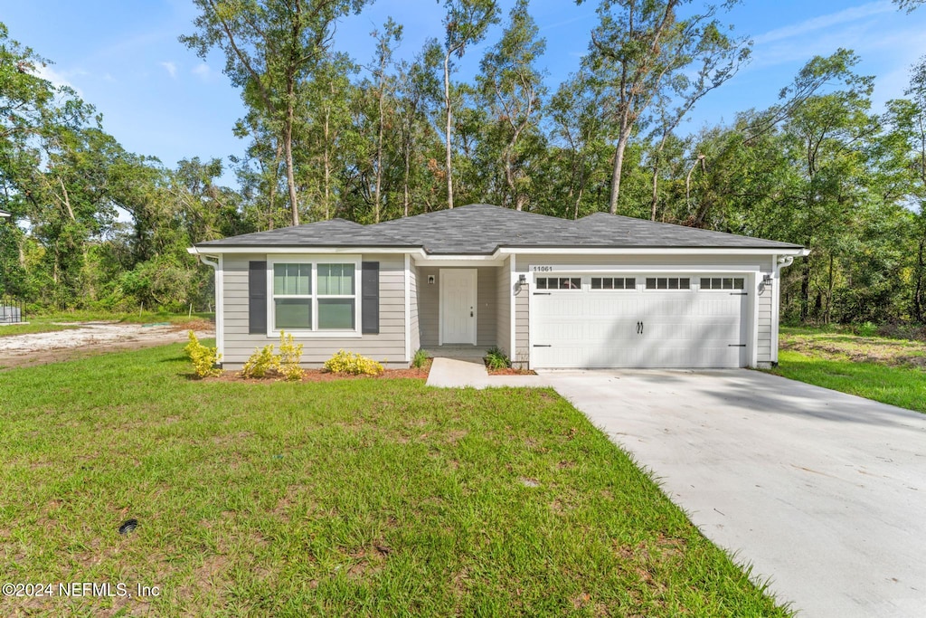 ranch-style home with a front yard and a garage