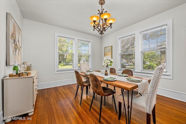 dining room with an inviting chandelier and dark hardwood / wood-style floors