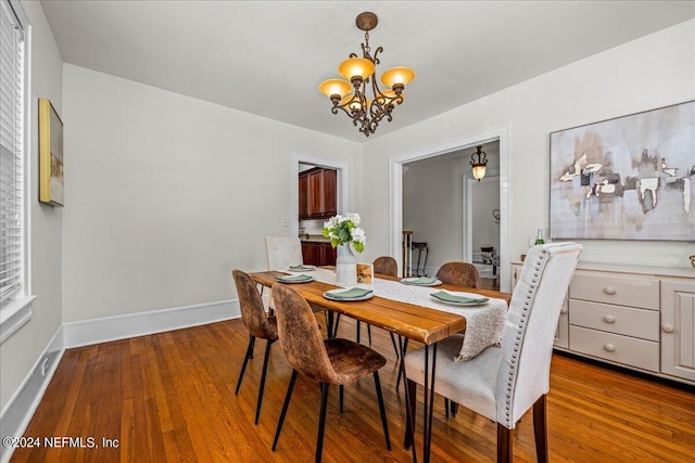 dining room with an inviting chandelier and hardwood / wood-style flooring